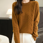 A woman wearing a brown long sleeve crew neck merino wool sweater.