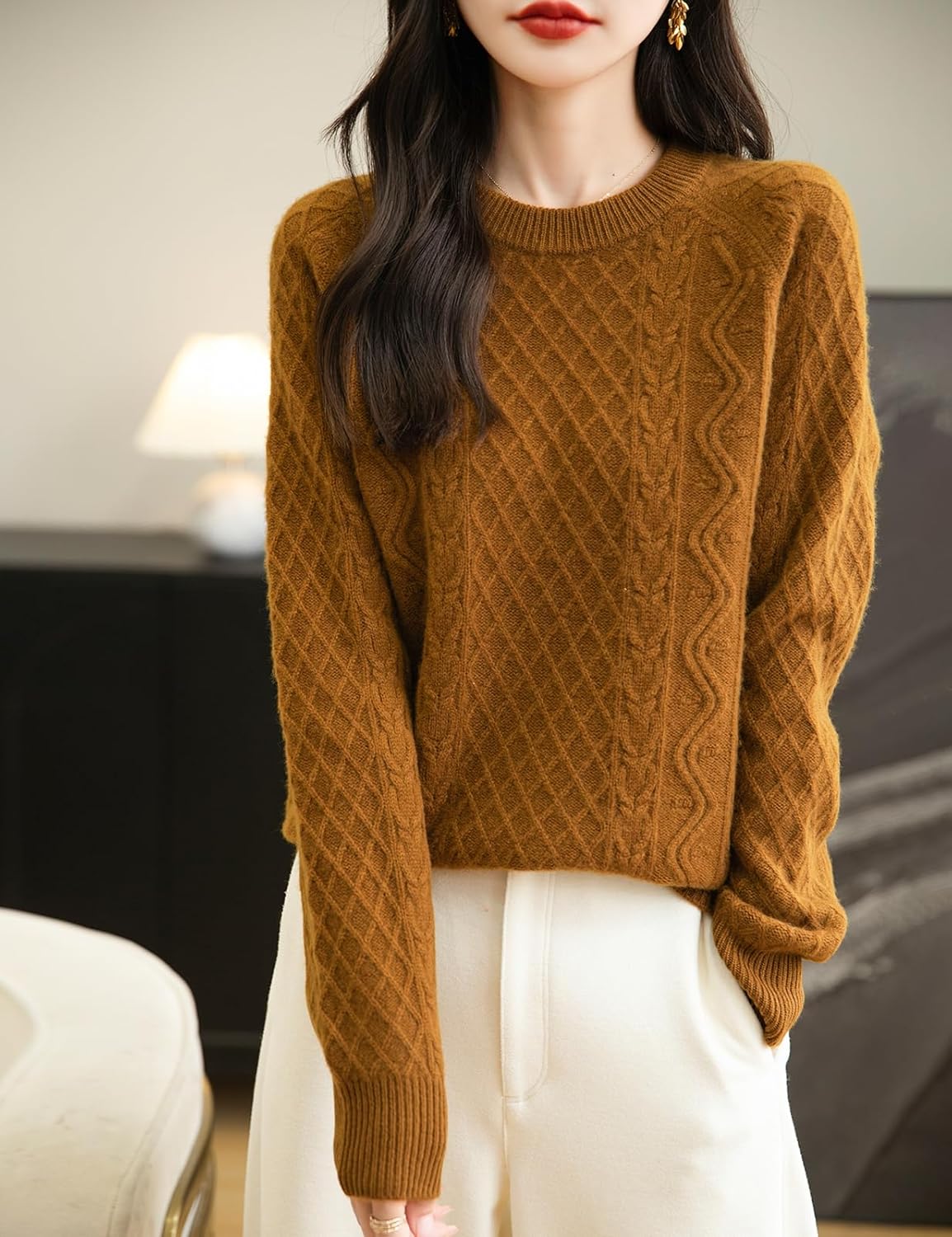 A woman wearing a brown long sleeve crew neck merino wool sweater.