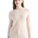 A woman wearing a long sleeve merino wool beige crewneck sweater.