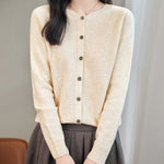 model wearing a women's beige merino wool crewneck cardigan sweater